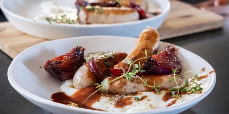 Pork Sausages with sweet & sour red onions on yoghurt mash
